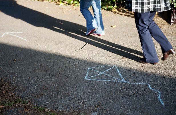 A couple participants walk toward the Fly and Remember kite decorating event at Gallup Park on Tuesday. The event encourages people to remember those they have lost by personalizing a kite and flying it. The event was organized by Hospice of Michigan. Daniel Brenner I AnnArbor.com